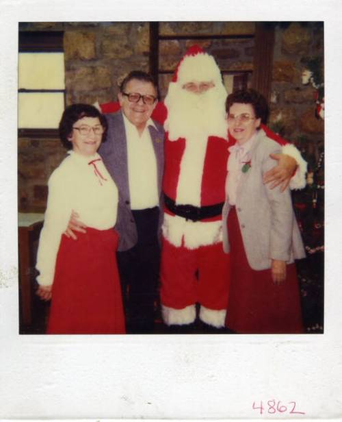 LHS members Mary McNerney on left, Representative Gus Bogina, Santa Claus, Velma Bogina on right in Legler Barn Museum.